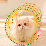 Cat playing with Spiral Cat Tunnel Toy, showing mouse and feather attachments